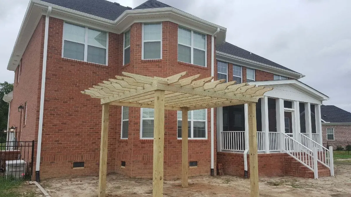 Attached pressure-treated pergola on a brick Chesapeake home
