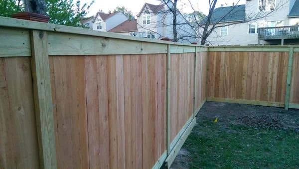 Admiral Design build: cedar infills in pressure-treated framing with trim and top cap