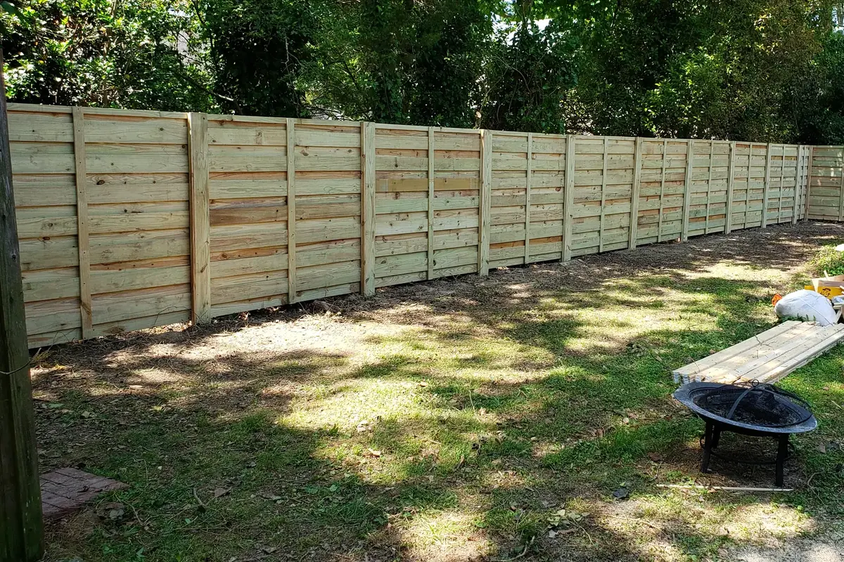 Wood privacy fence line installed by VB Fences in Hampton Roads
